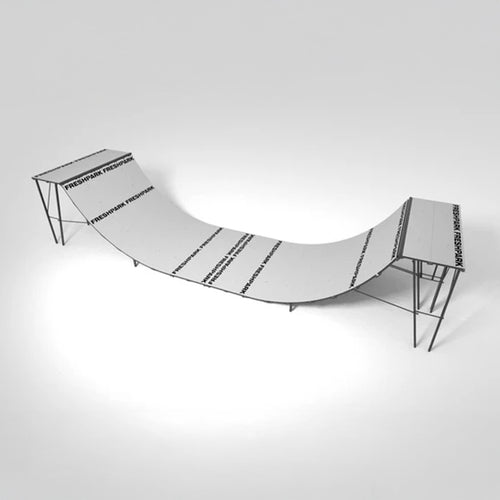 A black and white image of a half pipe mini ramp designed for skateboarding.