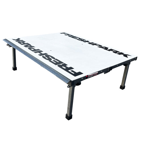 A foldable and portable skate ramp with the brand name 'Freshpark' on the surface, featuring black and gray colors with metal legs.