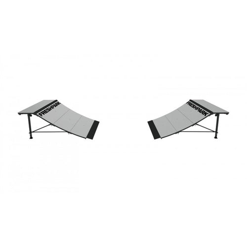Two black quarter pipe skate ramps with a white surface, viewed from an angled perspective.