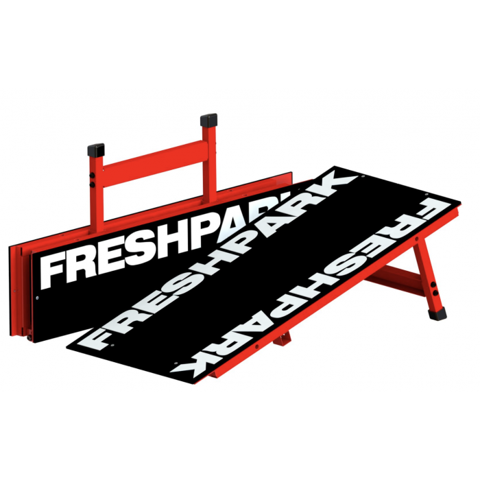 A portable wedge kicker ramp with red edges and black surface, featuring the text 'FRESH PARK' on it, designed for sports activities.